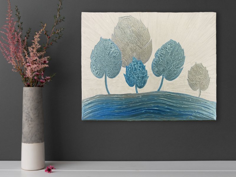 Textured mixed media art with blue trees by the ocean